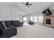Open living room with a fireplace, ample seating, and views of the kitchen and outdoors at 8225 W 825 N, Thorntown, IN 46071