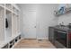 Convenient mudroom featuring built-in shelving, a door to the outside, and modern washer/dryer units at 8225 W 825 N, Thorntown, IN 46071