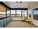 Charming sunroom featuring wood floors, a ceiling fan, and large windows overlooking a field at 8225 W 825 N, Thorntown, IN 46071