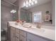 New bathroom featuring dual sinks, a large mirror, quartz countertops, and tiled enclosed shower at 8660 Hudson Way, Brownsburg, IN 46112