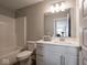 Bright bathroom with white vanity, large mirror, and a combined shower and tub at 8660 Hudson Way, Brownsburg, IN 46112