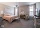 Serene primary bedroom with plush carpeting, elegant chandelier, and custom drapes at 8660 Hudson Way, Brownsburg, IN 46112