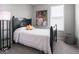 Bright bedroom featuring a black headboard, accent art, and a sunny window with blinds at 8660 Hudson Way, Brownsburg, IN 46112