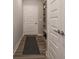 Hallway with doors, shelves and a gray mat on luxury vinyl plank floor at 8660 Hudson Way, Brownsburg, IN 46112