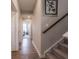 Hallway featuring luxury vinyl plank flooring leading to bedrooms and staircase at 8660 Hudson Way, Brownsburg, IN 46112