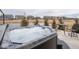 Outdoor hot tub and backyard with table and chairs, situated with a view of the neighborhood pond and homes at 8660 Hudson Way, Brownsburg, IN 46112