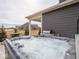 Relaxing hot tub ready for use with a grill and table nearby on a home's back patio at 8660 Hudson Way, Brownsburg, IN 46112