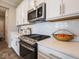 Kitchen counter with stainless appliances and a basket of oranges on white quartz countertop at 8660 Hudson Way, Brownsburg, IN 46112
