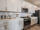 Bright kitchen featuring white cabinets, stainless steel appliances, and quartz countertops at 8660 Hudson Way, Brownsburg, IN 46112