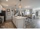 Spacious kitchen featuring a center island with bar seating and modern light fixtures at 8660 Hudson Way, Brownsburg, IN 46112