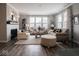 Cozy living room with ample seating, a fireplace, and an abundance of natural light at 8660 Hudson Way, Brownsburg, IN 46112