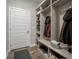 Organized mudroom with custom built-ins, bench, and storage for shoes, coats and accessories at 8660 Hudson Way, Brownsburg, IN 46112