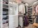 Open walk-in closet with shelves, drawers, and hanging rods for clothes and accessories at 8660 Hudson Way, Brownsburg, IN 46112