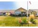 Expansive backyard featuring a covered patio, lush lawn, and picturesque landscaping at 8724 Faulkner Dr, Indianapolis, IN 46239