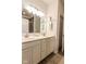 Well-lit bathroom featuring double sinks, white cabinets, and modern lighting at 8724 Faulkner Dr, Indianapolis, IN 46239