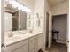 Bright bathroom with a double sink vanity, white cabinets, and updated fixtures at 8724 Faulkner Dr, Indianapolis, IN 46239