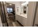 Well-lit bathroom with double vanity, white cabinets, and a walk-in shower at 8724 Faulkner Dr, Indianapolis, IN 46239