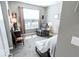 Bedroom with neutral paint, a comfortable chair, and a sun-filled window at 8724 Faulkner Dr, Indianapolis, IN 46239