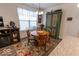 Cozy dining area with wood table, rug, and a large window for natural light at 8724 Faulkner Dr, Indianapolis, IN 46239