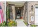 A close up view of the front door and address, framed by brick and garden at 8724 Faulkner Dr, Indianapolis, IN 46239