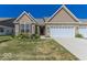 Charming single-story home with brick accents, landscaped yard, and attached two-car garage at 8724 Faulkner Dr, Indianapolis, IN 46239