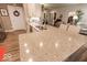 Large kitchen island with granite countertop, sink, and seating overlooking the living area at 8724 Faulkner Dr, Indianapolis, IN 46239