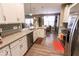 Kitchen featuring stainless steel appliances, white cabinets, and granite countertops with an open layout at 8724 Faulkner Dr, Indianapolis, IN 46239