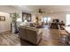 Open living room boasts wood flooring, a ceiling fan, and plenty of space for entertaining at 8724 Faulkner Dr, Indianapolis, IN 46239