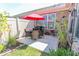 Cozy backyard patio featuring outdoor dining set, grill, and manicured landscaping, perfect for gatherings at 8724 Faulkner Dr, Indianapolis, IN 46239