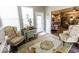 Cozy sunroom with natural light, floral armchairs, and backyard view, perfect for relaxation at 8724 Faulkner Dr, Indianapolis, IN 46239