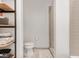 Modern bathroom with a glass-enclosed shower, toilet, and convenient shelving at 877 N East St # 103, Indianapolis, IN 46202