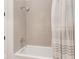 Updated bathroom with a shower over tub and neutral tile surround and fixtures at 877 N East St # 103, Indianapolis, IN 46202
