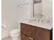 Modern bathroom features a wood vanity with a white countertop and updated fixtures at 877 N East St # 103, Indianapolis, IN 46202