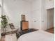 Stylish bedroom with a cozy sitting area, hardwood floors, and ample natural light at 877 N East St # 103, Indianapolis, IN 46202