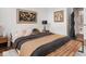 Bedroom featuring a large bed, decorative pillows, and a stylish bench at 877 N East St # 103, Indianapolis, IN 46202
