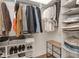 Well-organized walk-in closet with ample storage space for clothing and shoes at 877 N East St # 103, Indianapolis, IN 46202