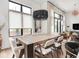 This dining room is illuminated by a modern chandelier above a large wooden table with seating for eight at 877 N East St # 103, Indianapolis, IN 46202