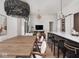 Open-concept living with natural light, modern chandeliers, and hardwood floors flow through dining and living areas at 877 N East St # 103, Indianapolis, IN 46202
