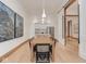 Bright dining area with a view into the modern kitchen, featuring sleek white cabinets and stainless steel appliances at 877 N East St # 103, Indianapolis, IN 46202