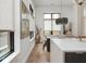 The dining area showcases natural light, a contemporary light fixture, and seamless flow to the living spaces at 877 N East St # 103, Indianapolis, IN 46202