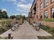 Well maintained walkway with seating leading to condo building entrance at 877 N East St # 103, Indianapolis, IN 46202
