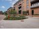 Exterior view of the building with landscaped courtyard, showcasing modern brick architecture at 877 N East St # 103, Indianapolis, IN 46202