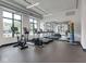 Bright gym with treadmills, elliptical, and free weights next to large windows and a mirror at 877 N East St # 103, Indianapolis, IN 46202