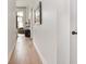 Hallway with hardwood floors leading into a bright living space at 877 N East St # 103, Indianapolis, IN 46202