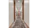 Neutral toned hallway with decorative sconces and wood trim at 877 N East St # 103, Indianapolis, IN 46202