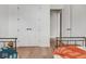 Hallway featuring hardwood floors, white doors, and neutral walls at 877 N East St # 103, Indianapolis, IN 46202