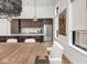 Modern kitchen featuring stainless steel appliances, a spacious island and a decorative chandelier at 877 N East St # 103, Indianapolis, IN 46202
