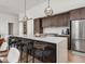 Contemporary kitchen with a large island, pendant lighting, and modern seating around the countertop bar at 877 N East St # 103, Indianapolis, IN 46202