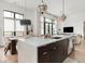 The modern kitchen has a waterfall island, pendant lighting, and leads into the dining and living areas at 877 N East St # 103, Indianapolis, IN 46202