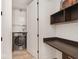 Bright laundry room equipped with modern washer and dryer, built-in shelving and desk at 877 N East St # 103, Indianapolis, IN 46202